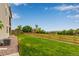 Long backyard with lush grass and wood fence bordering community green space at 6990 E 132Nd Pl, Thornton, CO 80602