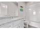 Well-lit bathroom with a modern vanity, granite counters, and tiled shower at 6990 E 132Nd Pl, Thornton, CO 80602