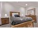 Bright bedroom featuring a wooden bed frame, neutral walls and carpet, and ample natural light at 6990 E 132Nd Pl, Thornton, CO 80602