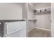Spacious walk-in closet with shelves and ample storage space and neutral color palette at 6990 E 132Nd Pl, Thornton, CO 80602