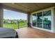 Covered deck showcasing a seating area and sliding glass doors, leading to indoor dining space at 6990 E 132Nd Pl, Thornton, CO 80602