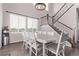 Open dining room with staircase, hardwood floors, large windows, and a stylish chandelier at 6990 E 132Nd Pl, Thornton, CO 80602