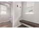 Functional entryway features a built-in bench, hooks, and natural light at 6990 E 132Nd Pl, Thornton, CO 80602