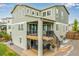 Two-story home with a covered deck, stairs to the yard, and a lower deck with a hot tub at 6990 E 132Nd Pl, Thornton, CO 80602