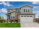 Charming two-story home with gray siding, stone accents, and a well-maintained front yard at 6990 E 132Nd Pl, Thornton, CO 80602