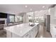 Spacious kitchen with an island, stainless appliances and a seamless flow to the living and dining areas at 6990 E 132Nd Pl, Thornton, CO 80602
