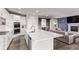 Bright, open kitchen with a large island and views into the living room and dining area at 6990 E 132Nd Pl, Thornton, CO 80602