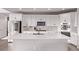 Modern kitchen featuring white cabinets, stainless steel appliances, and a spacious quartz island at 6990 E 132Nd Pl, Thornton, CO 80602