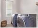 Laundry room with window, and modern washer and dryer at 6990 E 132Nd Pl, Thornton, CO 80602