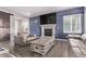 Comfortable living room with a fireplace, TV, and barn door for a cozy, modern feel at 6990 E 132Nd Pl, Thornton, CO 80602