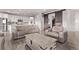 Open-concept living area with a modern kitchen and barn door accents creating a stylish space at 6990 E 132Nd Pl, Thornton, CO 80602