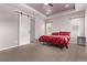 Spacious primary bedroom featuring recessed lights, neutral walls, and a sliding barn door at 6990 E 132Nd Pl, Thornton, CO 80602