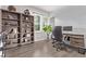 Bright office space with built-in shelving, a desk, and a view from the large window at 6990 E 132Nd Pl, Thornton, CO 80602