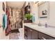 Stylish bathroom showcases decorative wall paneling, updated fixtures, and ample cabinet space at 2800 W Centennial Dr # I, Littleton, CO 80123