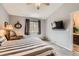 Inviting bedroom boasts natural light, a mounted television, and ensuite bathroom access at 2800 W Centennial Dr # I, Littleton, CO 80123