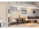 Charming dining area with a rustic wooden table and upholstered chairs under stylish pendant lighting at 2800 W Centennial Dr # I, Littleton, CO 80123