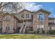 Inviting exterior of a multi-story home featuring stone accents, a landscaped yard, and a charming entryway at 2800 W Centennial Dr # I, Littleton, CO 80123