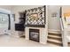 Modern fireplace features a unique tile surround and is flanked by built-in shelves for decor at 2800 W Centennial Dr # I, Littleton, CO 80123