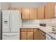 Kitchen features ample storage space with wooden cabinets and modern white appliances at 2800 W Centennial Dr # I, Littleton, CO 80123