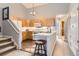 Bright kitchen featuring light wood cabinetry, an island with seating, and stainless steel appliances at 2800 W Centennial Dr # I, Littleton, CO 80123