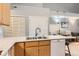 Open kitchen featuring spacious countertops, stainless steel sink, and modern appliances at 2800 W Centennial Dr # I, Littleton, CO 80123