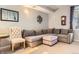 Comfortable living room features plush sectional sofa, accent chair, and a wall mounted art display at 2800 W Centennial Dr # I, Littleton, CO 80123