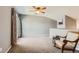 Open living room with neutral paint, plush carpet, and a door leading to the patio at 2800 W Centennial Dr # I, Littleton, CO 80123