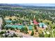 Aerial view of community amenities: tennis courts, pool, clubhouse, and green spaces at 7773 Gunsight Pass, Littleton, CO 80127