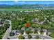 Aerial view of a home in a neighborhood with a backdrop of mountains and lush greenery at 7773 Gunsight Pass, Littleton, CO 80127