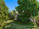 Expansive backyard featuring a well-maintained lawn and mature trees for shade and privacy at 7773 Gunsight Pass, Littleton, CO 80127