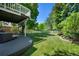 Well-maintained backyard with lush green grass, deck and fenced perimeter at 7773 Gunsight Pass, Littleton, CO 80127