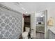 Bathroom features include a tub, patterned shower curtain, toilet and shelving at 7773 Gunsight Pass, Littleton, CO 80127