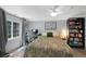 Light-filled bedroom features a ceiling fan, large window, desk and bookshelves at 7773 Gunsight Pass, Littleton, CO 80127