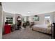 A well-lit bedroom with cozy carpet has large windows, plenty of space, and is perfect for working from home at 7773 Gunsight Pass, Littleton, CO 80127