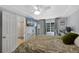 Bedroom features a ceiling fan, large window, TV, and attached bathroom at 7773 Gunsight Pass, Littleton, CO 80127