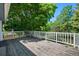 A spacious deck with white railing provides the perfect place to sit and relax, and enjoy the shade from mature landscaping at 7773 Gunsight Pass, Littleton, CO 80127