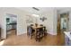 Bright dining room featuring a stylish light fixture and a view into the kitchen at 7773 Gunsight Pass, Littleton, CO 80127