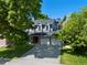 Charming home exterior with a well-manicured lawn and a spacious three-car garage at 7773 Gunsight Pass, Littleton, CO 80127