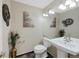 Stylish half bathroom featuring elegant decor and fixtures with tile flooring at 7773 Gunsight Pass, Littleton, CO 80127