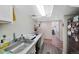 A basement kitchenette with stainless steel sink offers ample counter space and open access to the basement level at 7773 Gunsight Pass, Littleton, CO 80127