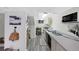 A basement kitchenette features white appliances and lots of counter space perfect for entertaining Gathering and friends at 7773 Gunsight Pass, Littleton, CO 80127