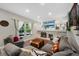 Comfortable living room with a brick fireplace, built-in shelving, and ample seating at 7773 Gunsight Pass, Littleton, CO 80127