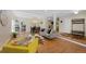 Open-concept living area with hardwood floors, modern decor, and a view of the staircase at 7773 Gunsight Pass, Littleton, CO 80127
