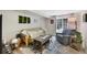 Comfortable living room with a modern area rug, futon sofa, cozy chair, and moss wall art at 7773 Gunsight Pass, Littleton, CO 80127