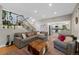 Comfortable living room boasts stylish decor, staircase, and open layout to the kitchen at 7773 Gunsight Pass, Littleton, CO 80127