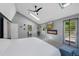 Bright main bedroom features skylights, modern fireplace, wall-mounted television, and exterior access at 7773 Gunsight Pass, Littleton, CO 80127