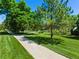 Well-maintained green space and walking path creating a welcoming neighborhood atmosphere at 7773 Gunsight Pass, Littleton, CO 80127
