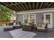 Inviting covered outdoor living space with comfortable seating and a cozy fire pit for relaxation at 7773 Gunsight Pass, Littleton, CO 80127