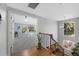 Upstairs landing features hardwood floors with a fireplace and television in the main bedroom at 7773 Gunsight Pass, Littleton, CO 80127