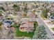Aerial view of a home showcasing its well-manicured yard and mature trees in a peaceful neighborhood at 8320 W Harvard Dr, Lakewood, CO 80227